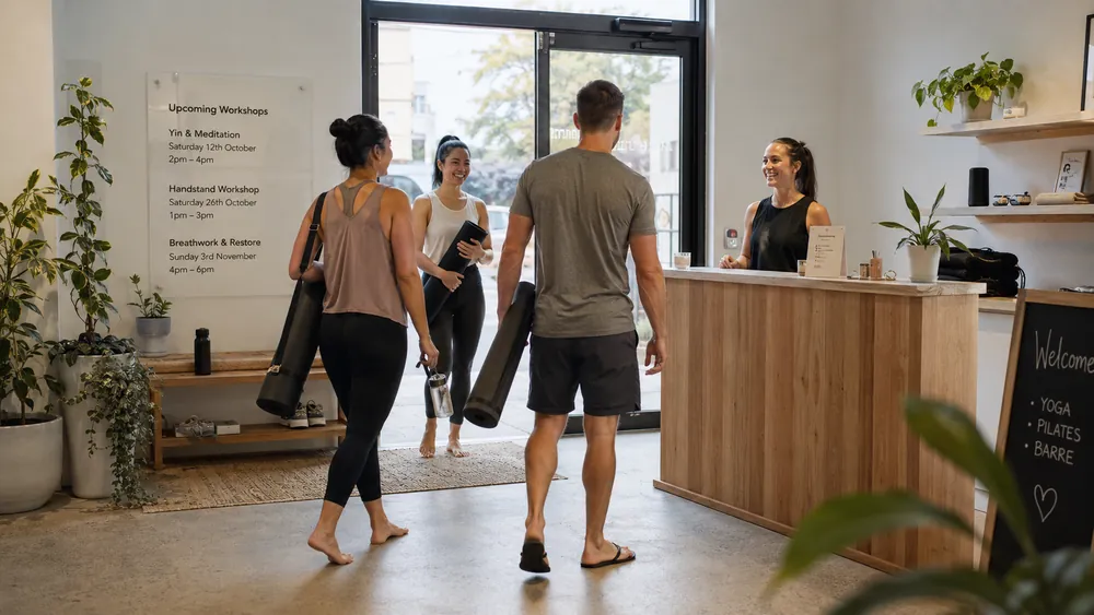 Members checking in at a studio reception desk